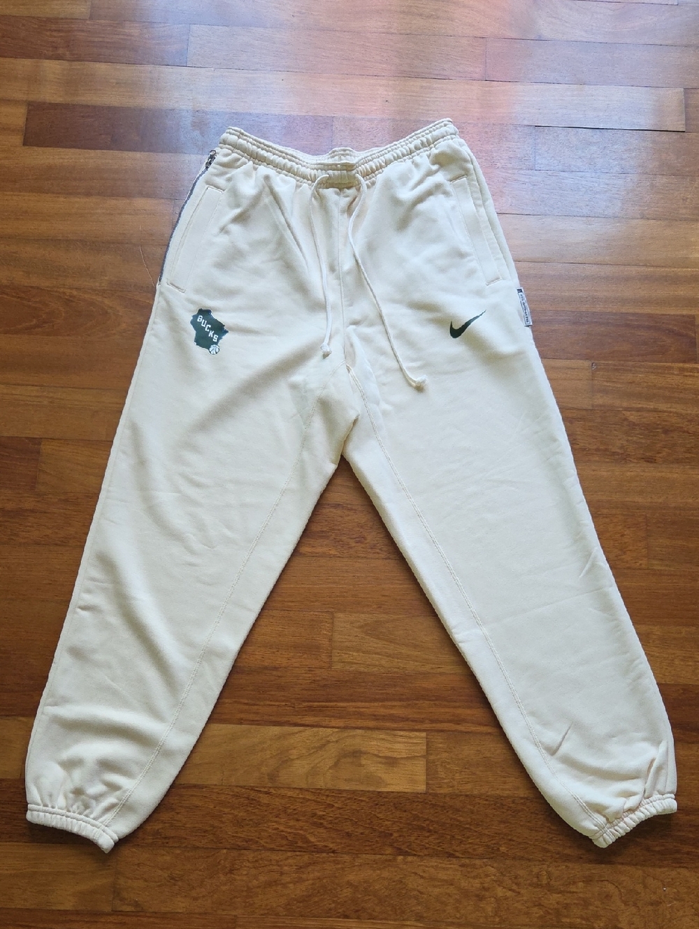 Mens Nike Milwaukee Bucks Cream Joggers with Green Swoosh